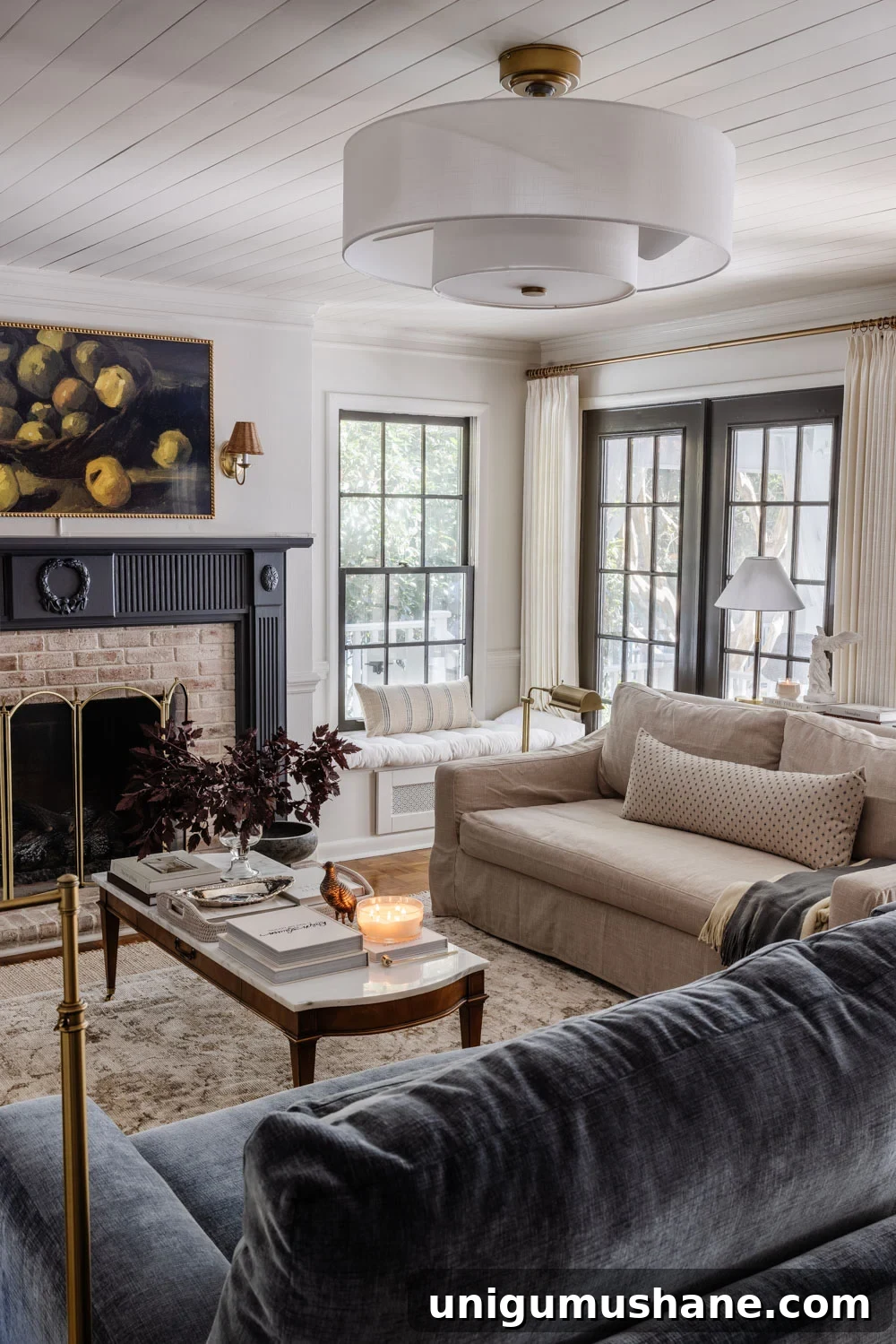8 Years of Living Room Renovation and Design 11 living room with blue fireplace mantel, marble coffee table, and modern fandelier