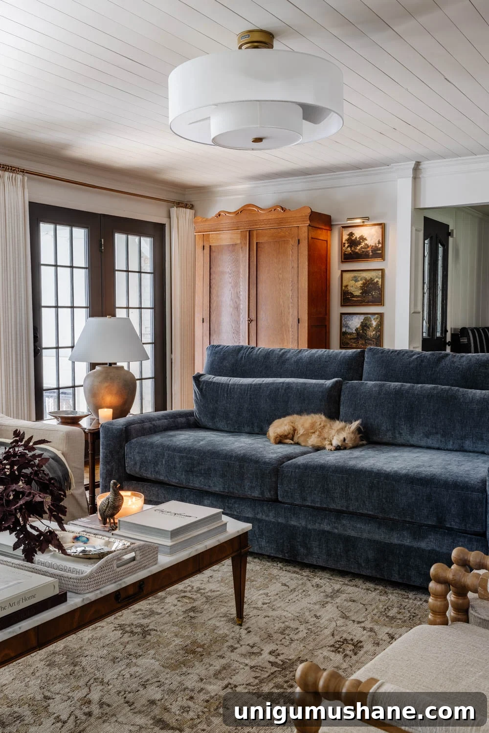 8 Years of Living Room Renovation and Design 10 blue sofa in living room with armoire mudroom