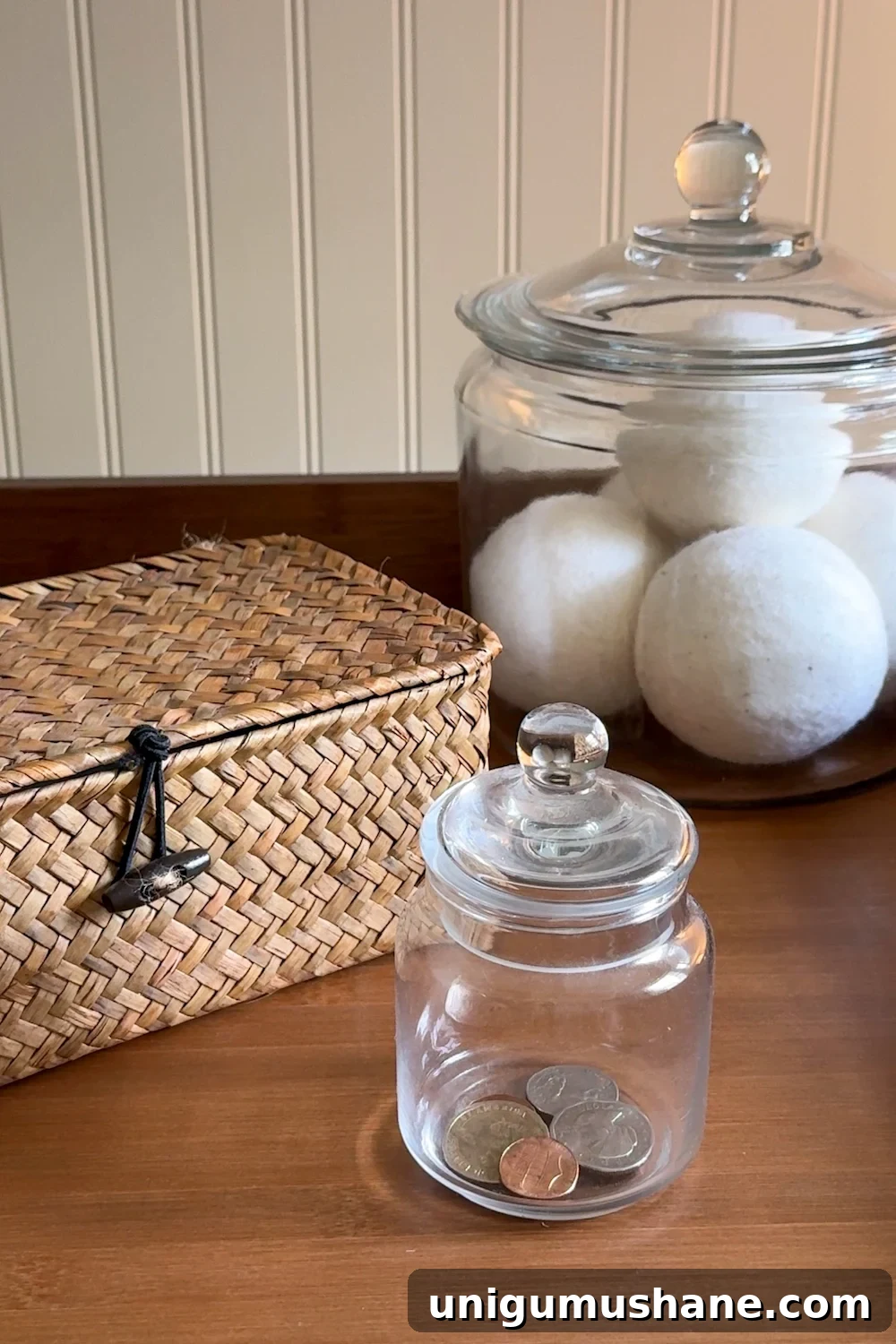 Maximize Storage in a Small Laundry Room 23 small laundry room organization - basket and apothecary jars for loose change, lost socks, and wool dryer balls