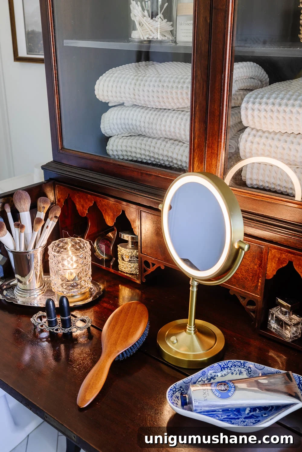 Turn a Secretary Desk Into a Makeup Vanity for Small Bathrooms 6 apothecary jars in secretary desk