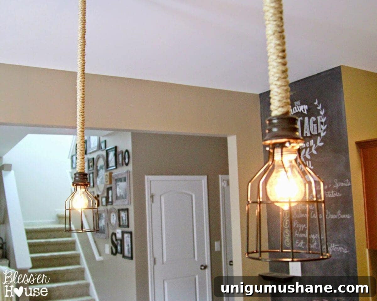 DIY industrial pendant lights in kitchen with chalkboard and gallery wall