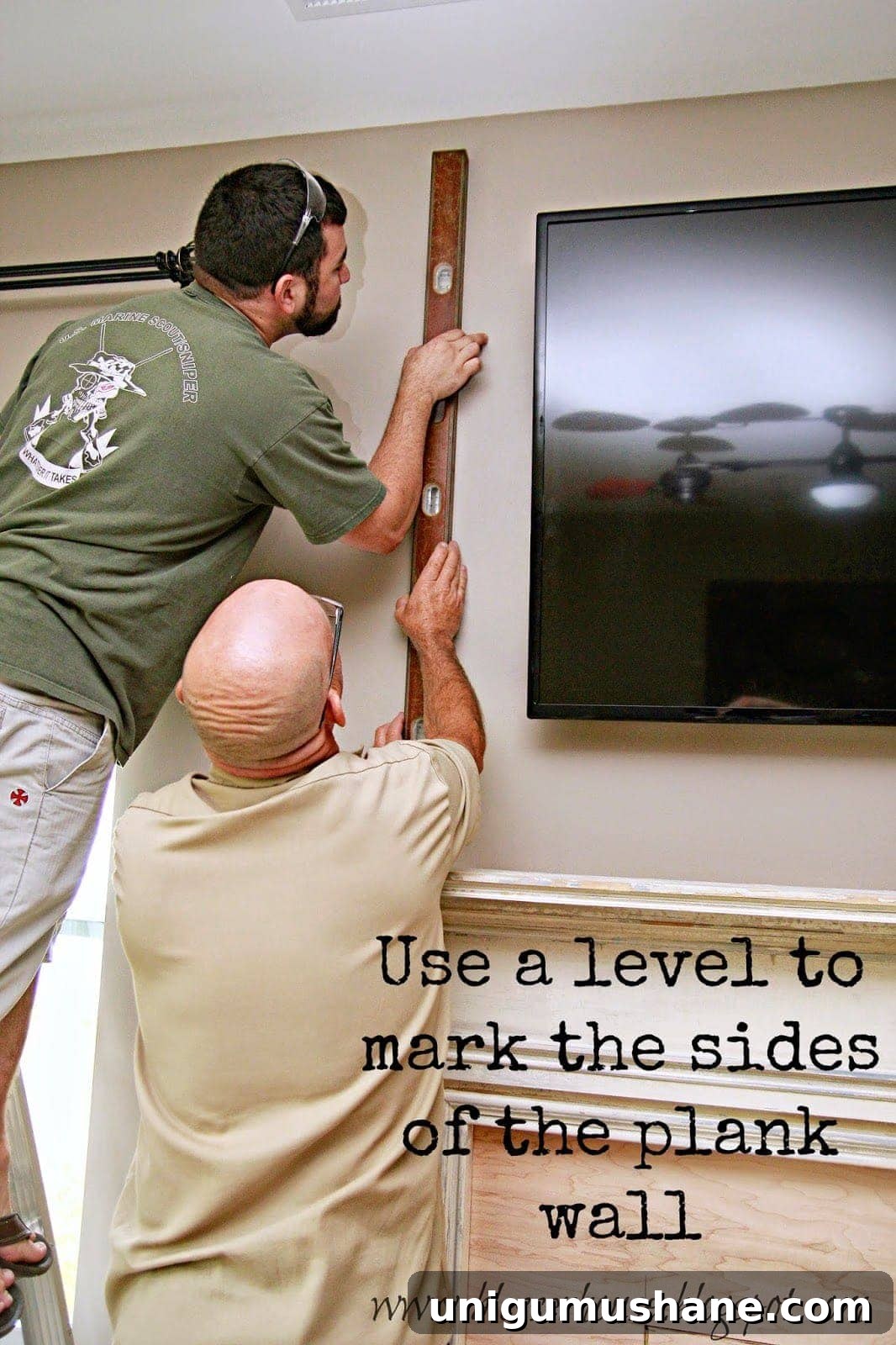 How to Build a Faux Fireplace Entertainment Center: Part 2 3 marking studs with a level