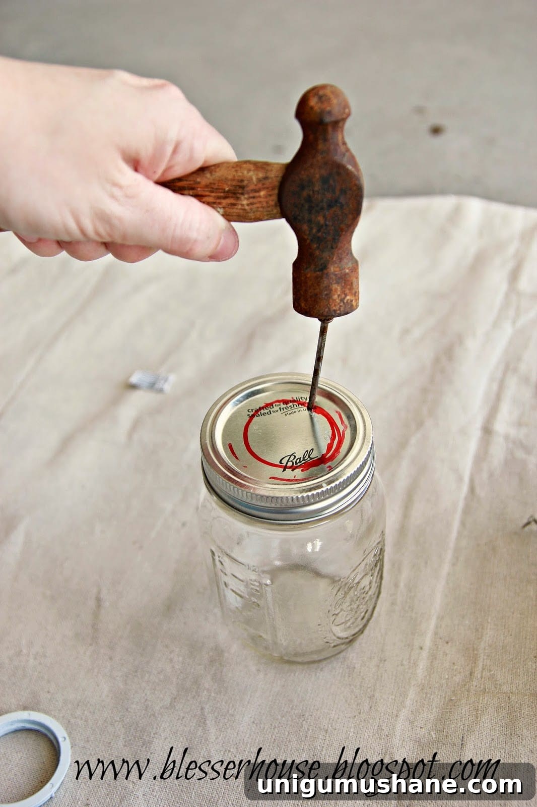 DIY Mason Jar Vanity Light for Rustic Bathroom Lighting 6 Nail holes punched around lid circle