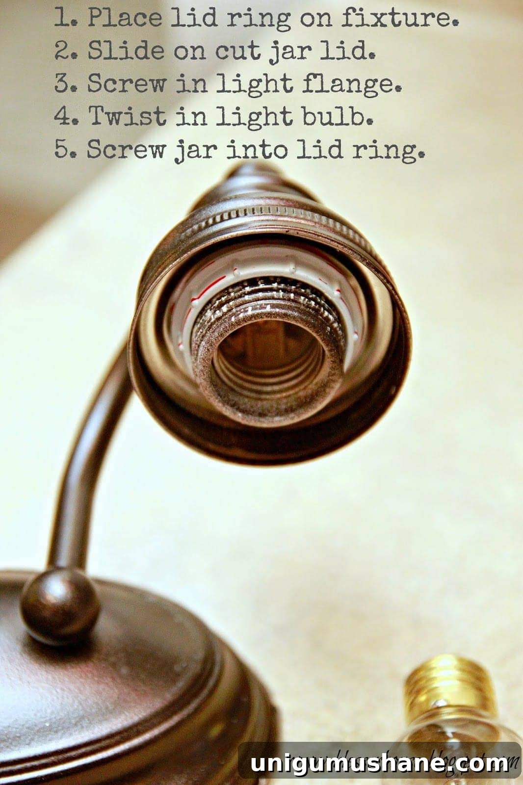 DIY Mason Jar Vanity Light for Rustic Bathroom Lighting 9 Mason jar fitted onto fixture with metal ring