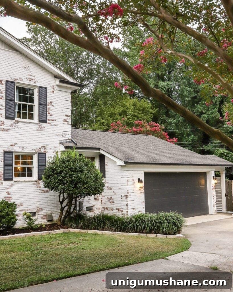 garage curb appeal with copper lanterns, star jasmine, and outdoor trash can hiding panels
