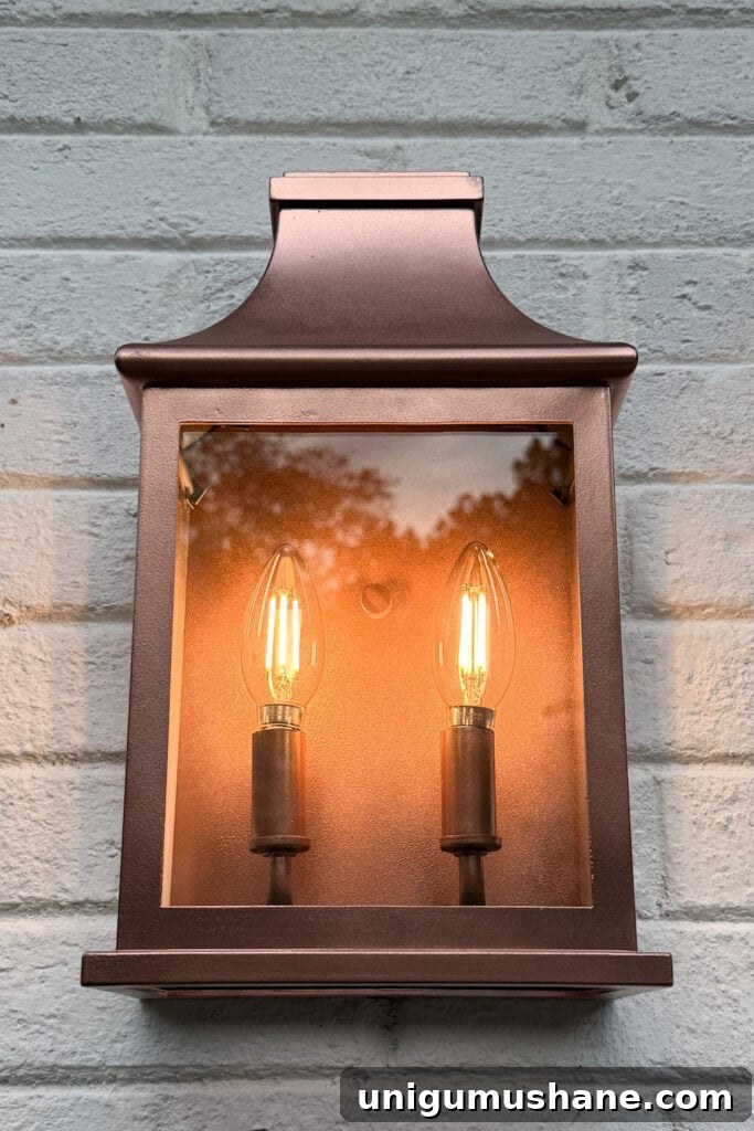 garage curb appeal with copper lanterns, star jasmine, and outdoor trash can hiding panels